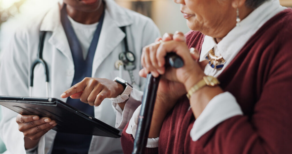 A photo of a doctor and a woman learning more about Medicare & the ESRD rule